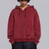Rode, door de zon verbleekte hoodie met rits en wafelvoering