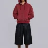 Rode, door de zon verbleekte hoodie met rits en wafelvoering
