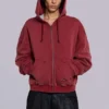 Rode, door de zon verbleekte hoodie met rits en wafelvoering