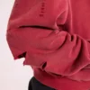 Rode, door de zon verbleekte hoodie met rits en wafelvoering